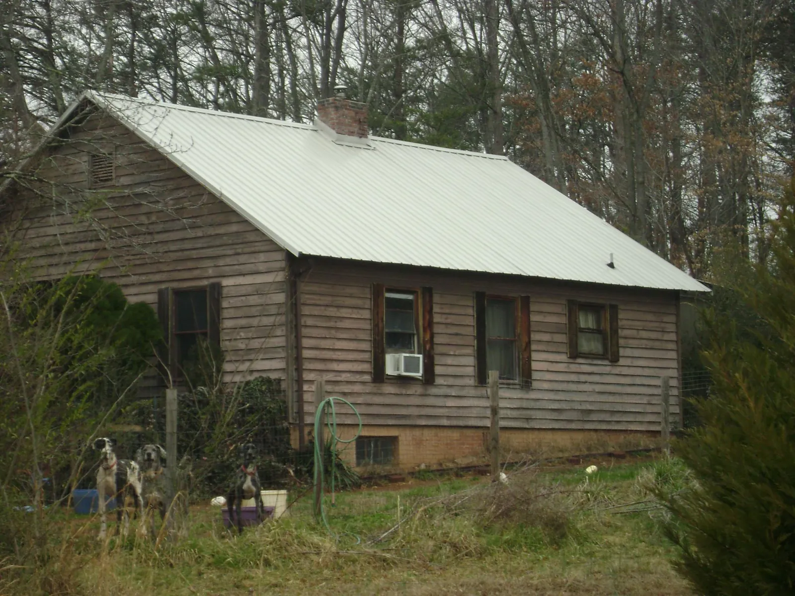 White metal roof on an old wood sided farmhouse, from a Metal Roof Installation job in Boxholm